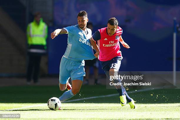 Filip Kostic of Hamburg challenges Geoff Cameron of Stoke City during the pre-season friendly match between Hamburger SV and Stoke City at...