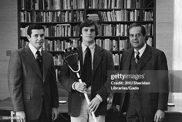 Three time All-American lacrosse player for Johns Hopkins University, Mike O'Neill, wears a blazer and holds his stick to pose with head coach for...