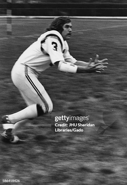 Johns Hopkins University football player Bill Nolan reaches his hands out in anticipation of a pass, 1972. .