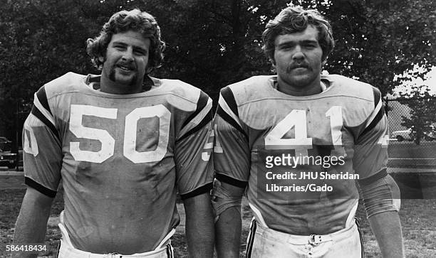 Half-length standing portrait of two Johns Hopkins University football players standing on a field, 1970. .