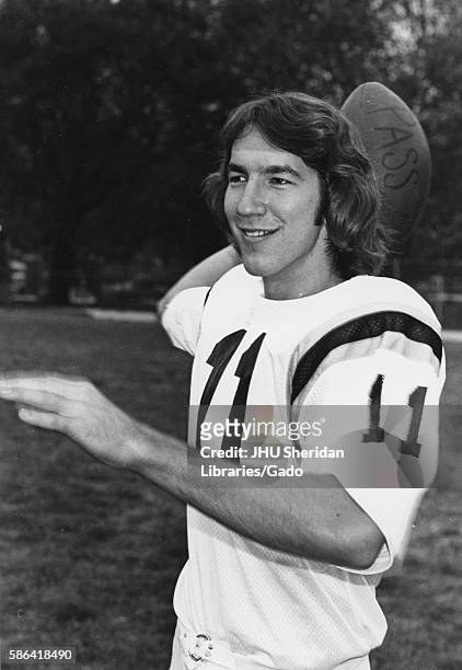 Johns Hopkins University football player Bill Norbeck smiling, about to toss a football, 1973. .