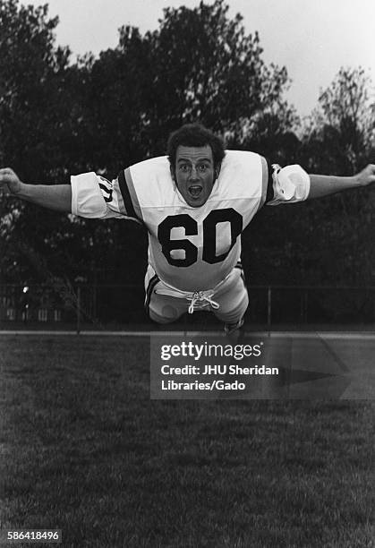 Johns Hopkins University football player Keith Krantz on a field diving towards the camera, 1970. .