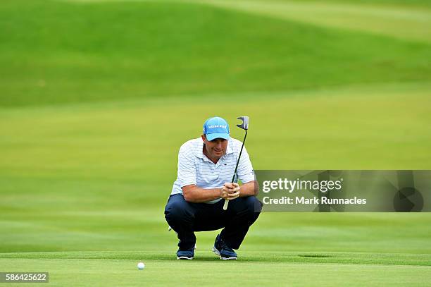 Anthony Wall of England lines up a putt on the green on hole 18 on day three of the Aberdeen Asset Management Paul Lawrie Matchplay at Archerfield...