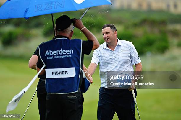 Anthony Wall of England with Oliver Fisher of England on hole 18 after winning their match on the fourth playoff hole on day three of the Aberdeen...