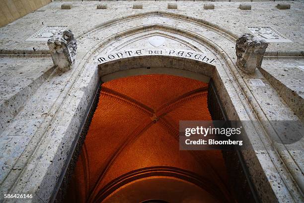 Engraved lettering sits above the entrance to the Banca Monte dei Paschi di Siena SpA headquarters in Siena, Italy, on Friday, Aug. 5, 2016. Banca...