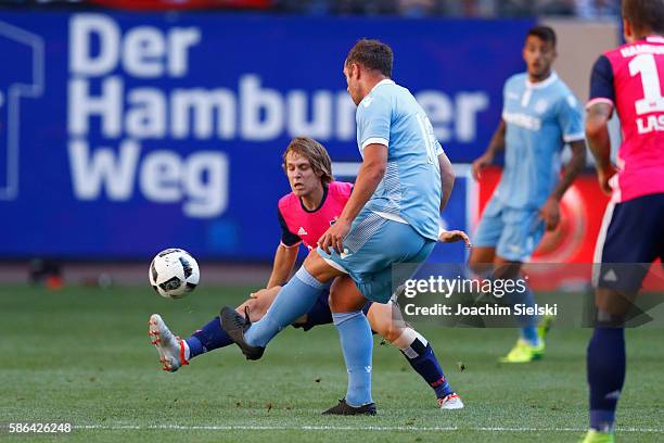 Alen Halilovic of Hamburg challenges Charlie Adam of Stoke City during the pre-season friendly match between Hamburger SV and Stoke City at...