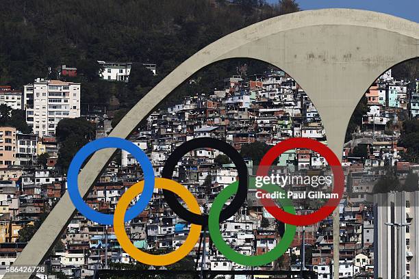 The Olympic Rings are seen with favelas in the background during the Men's Team Quarter Finals on Day 1 of the Rio 2016 Olympic Games at the...