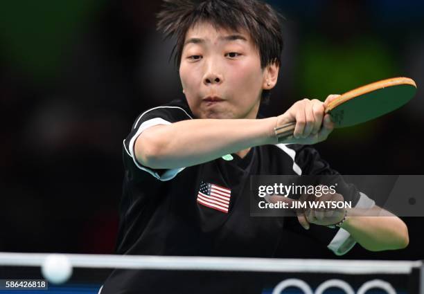 S Yue Wu hits a shot in her women's singles qualification round table tennis match at the Riocentro venue during the Rio 2016 Olympic Games in Rio de...