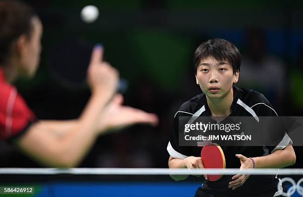 Slovakia's Eva Odorova hits a shot to USA's Yue Wu in their women's singles qualification round table tennis match at the Riocentro venue during the...