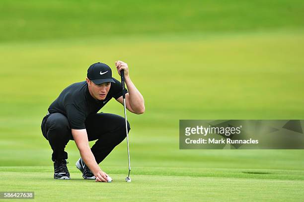 Oliver Fisher of England lines up a putt on hole 18 on day three of the Aberdeen Asset Management Paul Lawrie Matchplay at Archerfield Links Golf...