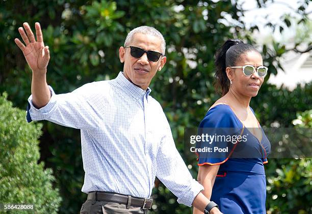 President Barack Obama waves to the assembled press as he and first lady Michelle Obama depart the White House August 6, 2016 in Washington, DC. The...