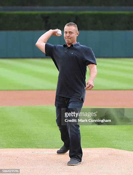 Former Detroit Tigers player Brandon Inge throws out the ceremonial first pitch prior to the game against the Kansas City Royals at Comerica Park on...