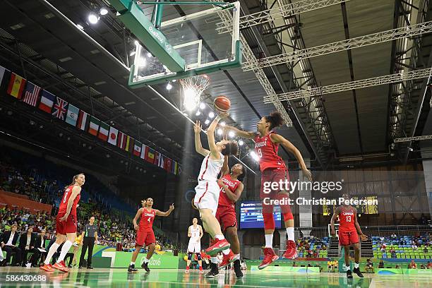 Di Wu of China attemtps a shot against Miranda Ayim of Canada during a Women's Basketball Preliminary Round game on Day 1 of the Rio 2016 Olympic...