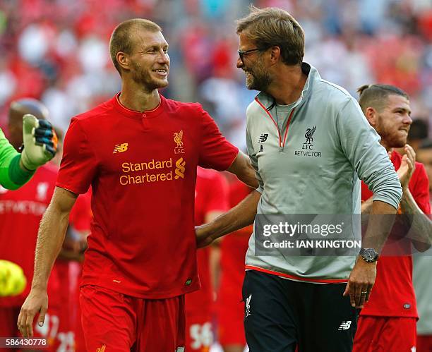 Liverpool's German manager Jurgen Klopp and Liverpool's Estonian defender Ragnar Klavan celebrate on the pitch after the pre-season International...