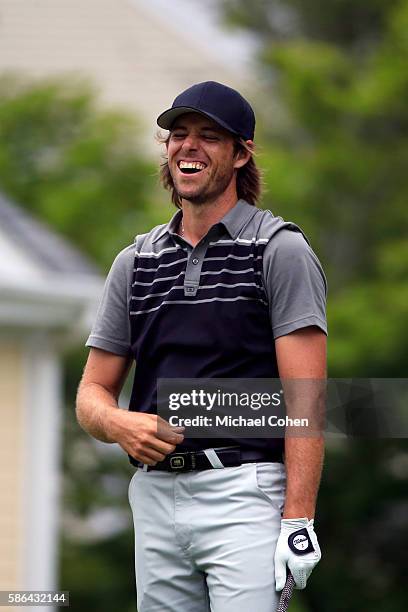 Aaron Baddeley of Australia reacts as a baby begins to cry as he attempts to play his shot from the seventh tee during the third round of the...