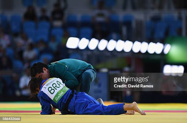 Sarah Menezes of Brazil is tended to after being defeated by Urantsetseg Munkhbat of Mongolia during the Women's -48 kg Repechage Judo contest on Day...