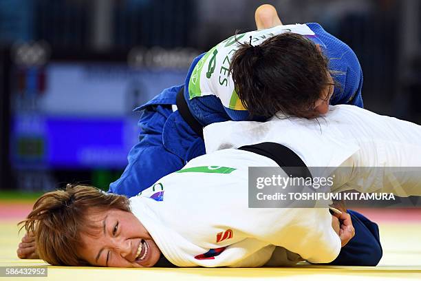 Mongolia's Urantsetseg Munkhbat competes with Brazil's Sarah Menezes during their women's -48kg judo contest repechage match of the Rio 2016 Olympic...