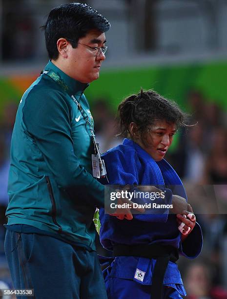 Sarah Menezes of Brazil is tended to after being defeated by Urantsetseg Munkhbat of Mongolia during the Women's -48 kg Repechage Judo contest on Day...