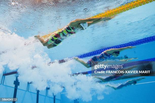 Brazil's Daynara De Paula competes in the Women's 100m Butterfly heat during the swimming event at the Rio 2016 Olympic Games at the Olympic Aquatics...