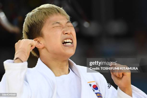 South Korea's Jeong Bokyeong reacts after defeating Cuba's Dayaris Mestre Alvarez in their women's -48kg judo contest semifinal A match of the Rio...