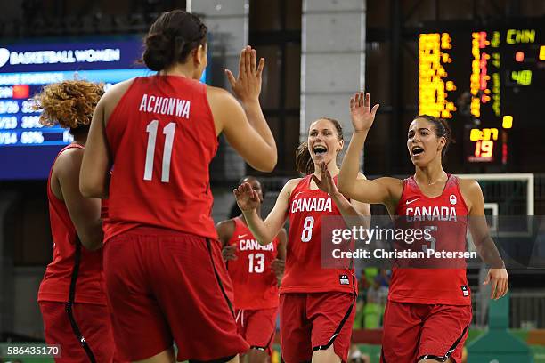 Natalie Achonwa, Kim Gaucher and Kia Nurse of Canada celebrate after scoring against China during a Women's Basketball Preliminary Round game on Day...