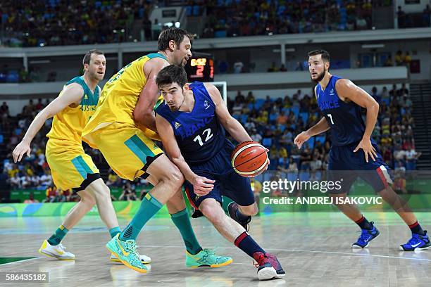 Australia's guard Damian Martin defends against France's guard Nando de Colo during a Men's round Group A basketball match between Australia and...