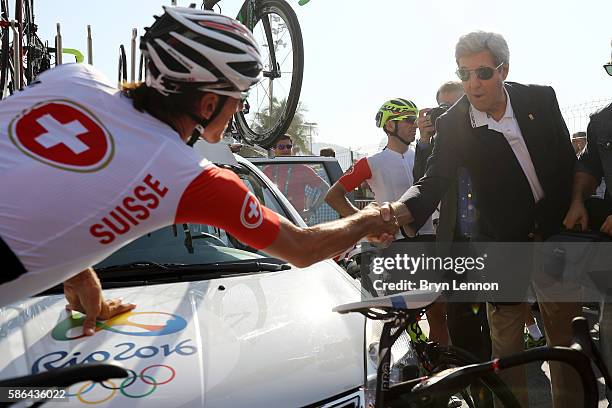 Secretary of State John Kerry shakes hands with Fabian Cancellara of Switzerland before the Men's Road Race on Day 1 of the Rio 2016 Olympic Games at...