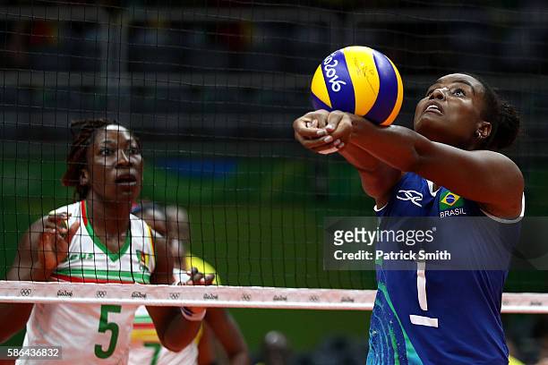 Fabiana Claudino of Brazil bumps a shot in front of Theorine Christelle Aboa Mbeza of Cameroon during the Women's Preliminary Pool A match between...