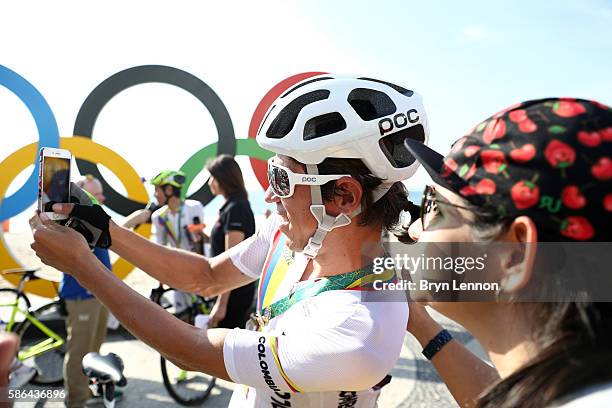 Rigoberto Uran Uran of Colombia takes selfie photographs before the Men's Road Race on Day 1 of the Rio 2016 Olympic Games at the Fort Copacabana on...