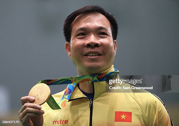 Xuan Vinh Hoang of Vietnam celebrates after winning the gold medal in the 10m Air Pistol Men's Finals on Day 1 of the Rio 2016 Olympic Games at the...