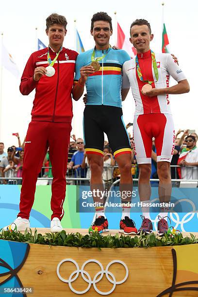 Silver medalist Jakob Fuglsang of Denmark, Gold medalist Greg van Avermaet of Belgium and Rafal Majka of Poland celebrates on the podium at the medal...