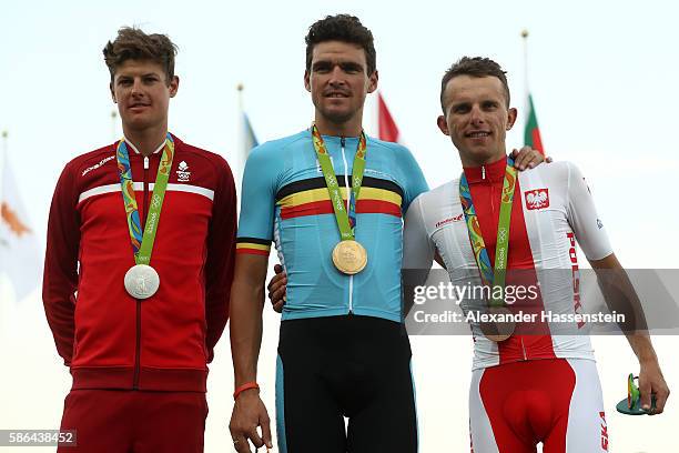 Silver medalist Jakob Fuglsang of Denmark, Gold medalist Greg van Avermaet of Belgium and bronze medalist Rafal Majka of Poland celebrate on the...