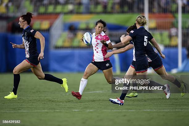 Japan's Yume Okuroda runs with the ball in the womens rugby sevens match between Britain and Japan during the Rio 2016 Olympic Games at Deodoro...