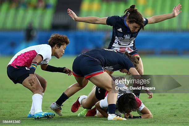 Yume Okuroda of Japan and Katy Mclean of Great Britain compete for the ball during a Women's Pool C rugby match between Great Britain and Japan on...