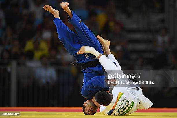 Diyorbek Urozboev of Uzbekistan competes against Amiran Papinashvili of Georgia in the Men's -60 kg Bronze Medal B contest on Day 1 of the Rio 2016...