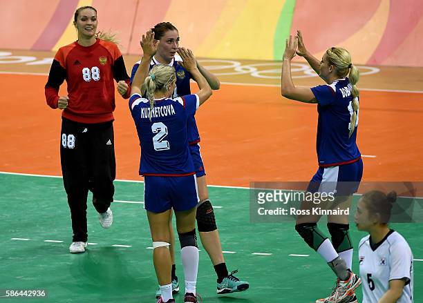 The Russian team celebrate victory during the Women's Hadball match between Russia and Korea on Day 1 of the Rio 2016 Olympic Games at Future Arena...