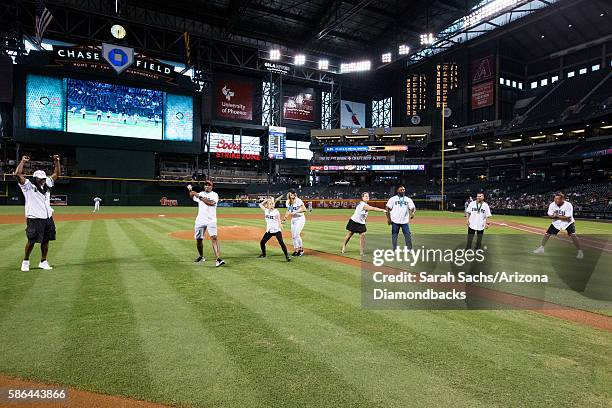 Olympic medalist Dwayne Evans, Roger Kingdom, Olga Korbut, Misty Hyman, Trina Jackson, Ernie Young, Augie Ojeda, and Dan Majerle throw out the...