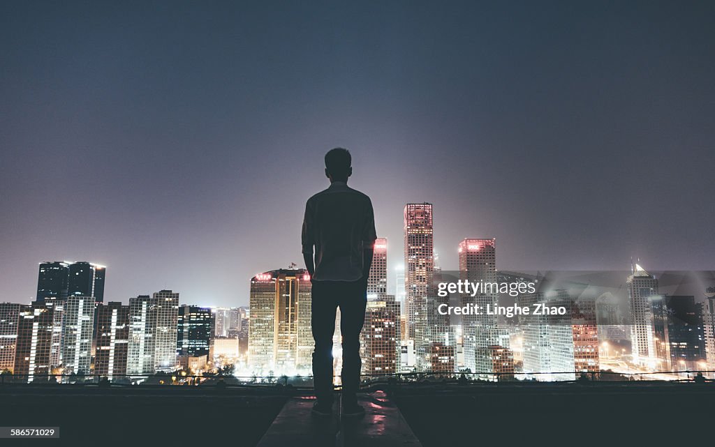 Standing on urban rooftop