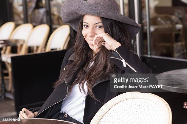 smiling young woman sitting at a sidewalk cafe. - jean marc payet stock-fotos und bilder