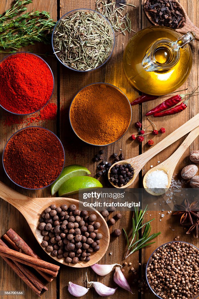 Exotic spices and herbs on rustic wood table