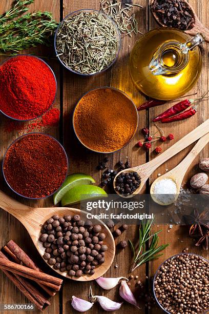 exotic spices and herbs on rustic wood table - spice stock pictures, royalty-free photos & images