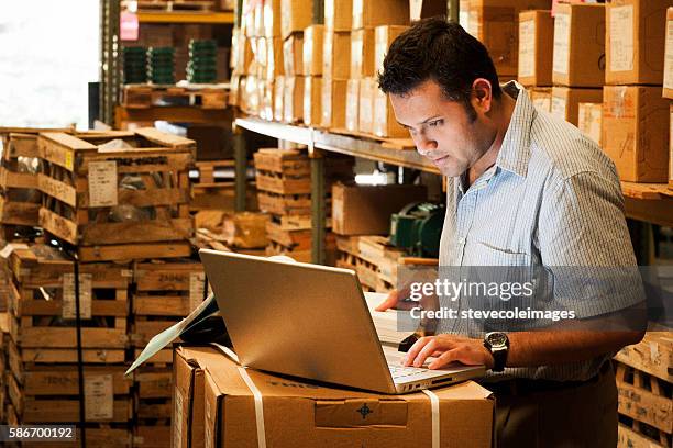 hispanic manager in warehouse - packaging manufacturing stock pictures, royalty-free photos & images
