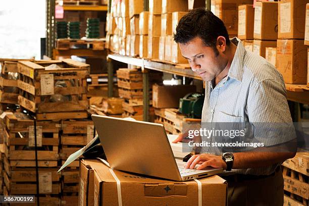 hispanic manager in warehouse - warehouse inventory stock pictures, royalty-free photos & images