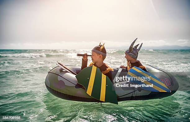 kids playing vikings at sea on a boat - boy exploring on beach stock pictures, royalty-free photos & images
