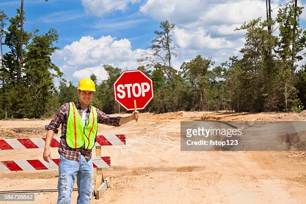 construction worker, flagman holds stop sign at job site. - road construction safety stock pictures, royalty-free photos & images