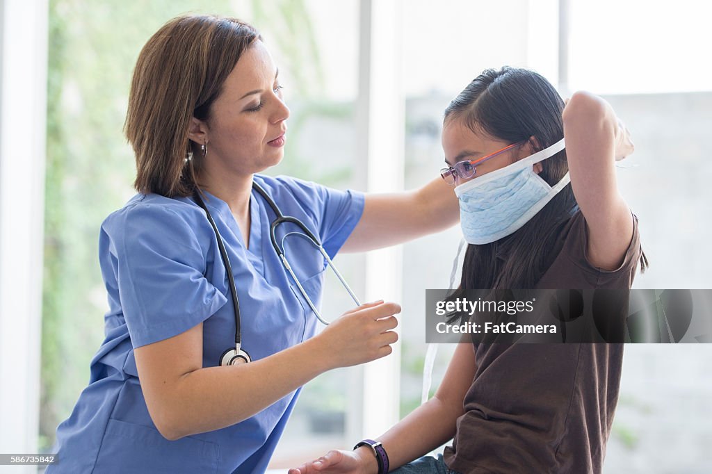 An Elementary Age Girl Is Getting A Check Up At The High-Res Stock ...