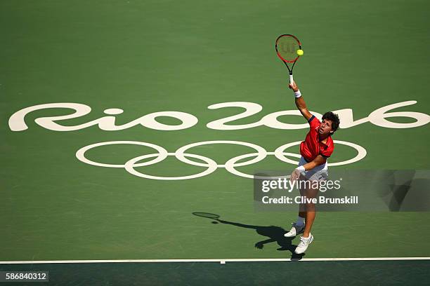 Carla Suarez Navarro of Spain serves against Ana Ivanovic of Serbia in their first round match on Day 1 of the Rio 2016 Olympic Games at the Olympic...