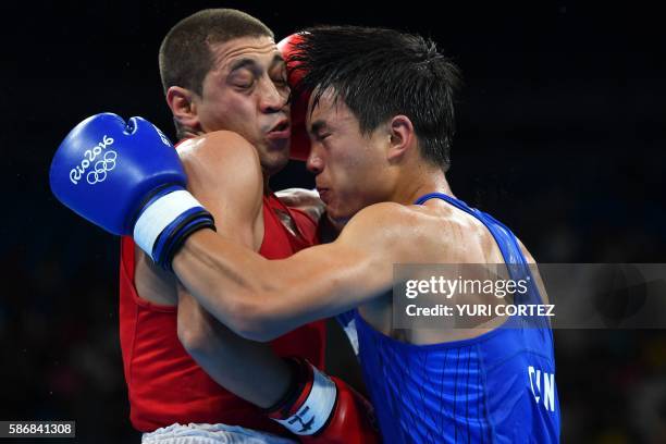 Tajikistan's Anvar Yunusov fights China's Shan Jun during the Men's Light match at the Rio 2016 Olympic Games at the Riocentro - Pavilion 6 in Rio de...