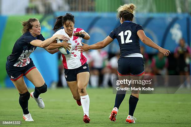 Yume Okuroda of Japan is tackled during a Women's Pool C rugby match between Great Britain and Japan on Day 1 of the Rio 2016 Olympic Games at...