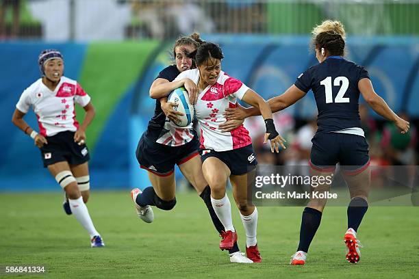 Yume Okuroda of Japan is tackled during a Women's Pool C rugby match between Great Britain and Japan on Day 1 of the Rio 2016 Olympic Games at...